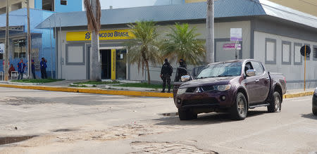 Policemen stand in front of the Banco do Brasil branch after a shootout between police and bank robbers, in Milagres, Brazil December 7, 2018. REUTERS/Agency Miseria/Normando Sracles?