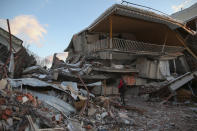 Collapsed buildings in Golbasi, in Adiyaman province, southern Turkey, Wednesday, Feb. 8, 2023. Thinly stretched rescue teams worked through the night in Turkey and Syria, pulling more bodies from the rubble of thousands of buildings toppled by a catastrophic earthquake. The death toll rose Wednesday to more than 10,000, making the quake the deadliest in more than a decade. (AP Photo/Emrah Gurel)