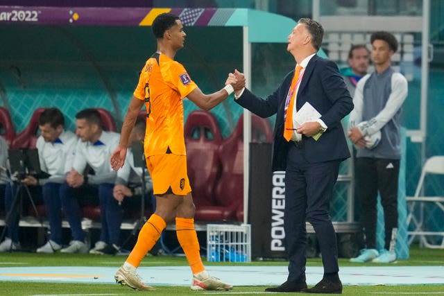 Cody Gakpo, left, is congratulated by Netherlands coach Louis van Gaal