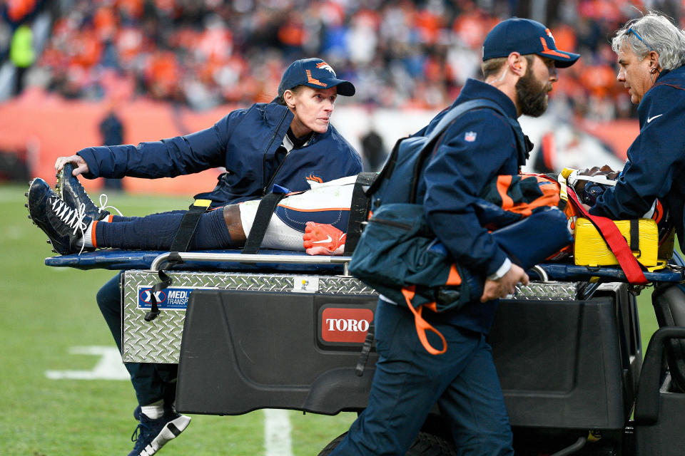 Denver Broncos quarterback Teddy Bridgewater is taken off the field on a cart by medical personnel after sustaining an injury during a game between the Denver Broncos and the Cincinnati Bengals at Empower Field at Mile High.