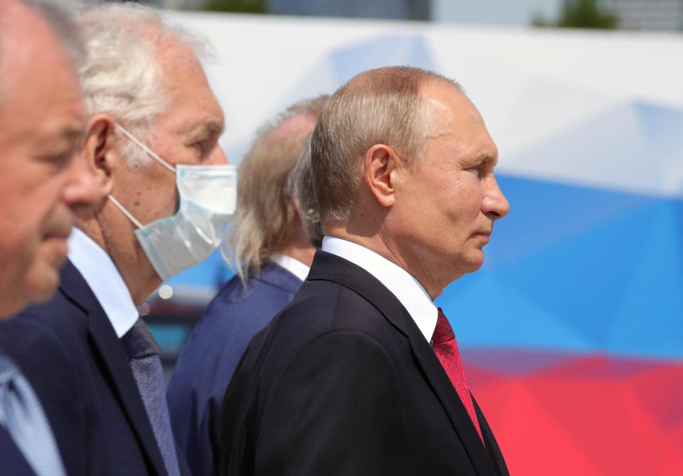 Russian President Vladimir Putin, right, attends a ceremony of handing Gold Stars medals to heroes of labor marking the Day of Russia holiday in Moscow, Russia, on Friday, June 12, 2020. The ceremony marked the first big public event Putin attended since announcing a nationwide lockdown more than two months ago. (Mikhail Klimentyev, Sputnik, Kremlin Pool Photo via AP)