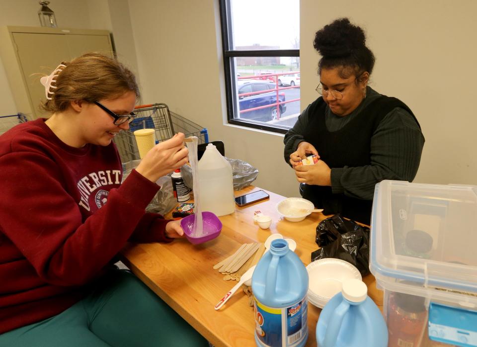 La Casa de Amistad staff Brianna Vital, left, and Gabi Morgan make slime to prepare for a youth program in the art room Dec. 7, 2022.