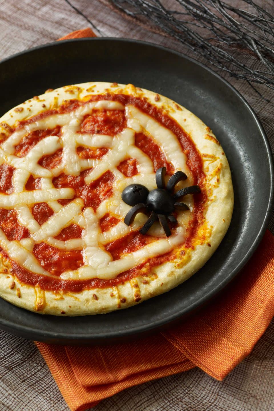 <p>Serve up a piping hot slice of spookiness with these super-simple pizzas made with pre-baked crust, pizza sauce, strategically placed string cheese, and a black olive spider.</p><p><a href="https://www.womansday.com/food-recipes/food-drinks/recipes/a10838/spiderweb-pizzas-recipe-122166/" rel="nofollow noopener" target="_blank" data-ylk="slk:Get the Spiderweb Pizza recipe.;elm:context_link;itc:0;sec:content-canvas" class="link "><em>Get the Spiderweb Pizza recipe.</em></a></p>