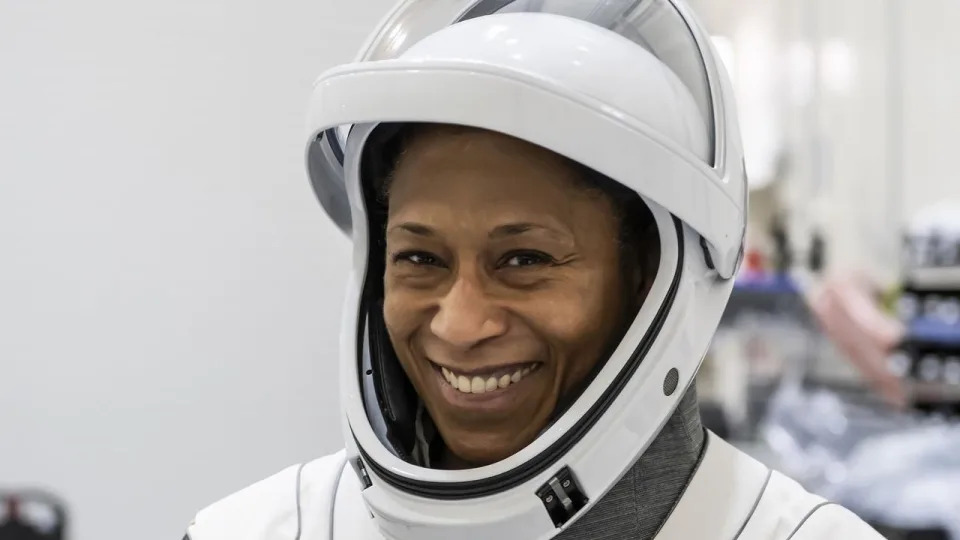 woman smiling in a spacesuit