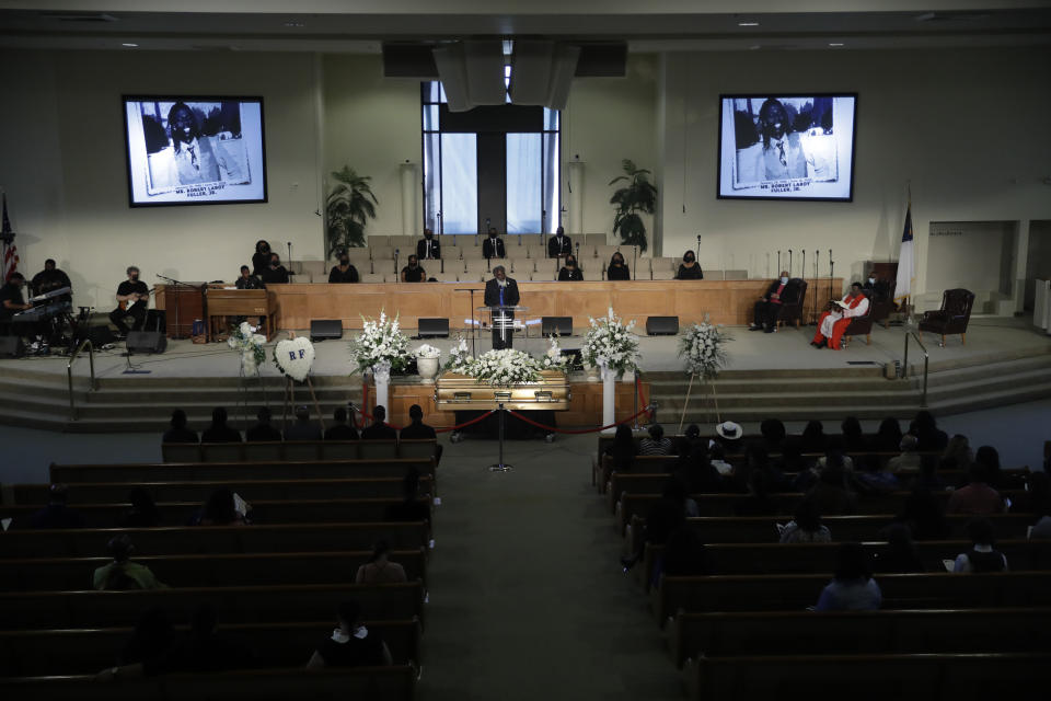 A pastor eulogizes Robert Fuller as attendees practice social distance during a funeral in his honor Tuesday, June 30, 2020, in Littlerock, Calif. Fuller, a 24-year-old Black man was found hanging from a tree in a park in a Southern California high desert city. Authorities initially said the death of Fuller appeared to be a suicide but protests led to further investigation, which continues. (AP Photo/Marcio Jose Sanchez)