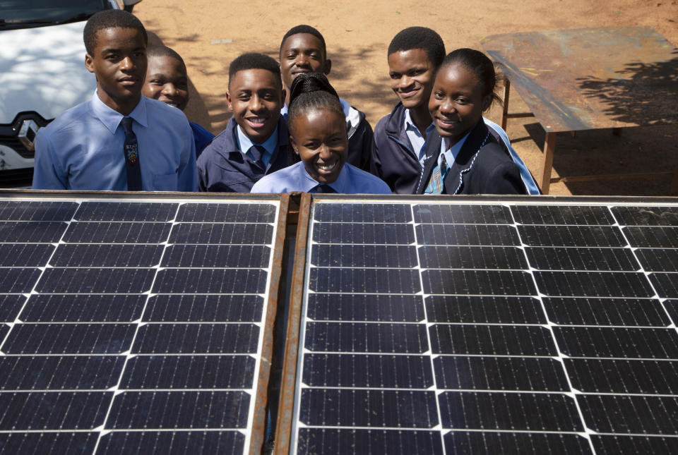 Students from the Soshanguve Automotive School of Specialization pose for a photograph behind solar panels on a train roof, north of Pretoria, South Africa, Monday, Nov. 14, 2022. Elections, coups, disease outbreaks and extreme weather are some of the main events that occurred across Africa in 2022. Experts say the climate crisis is hitting Africa “first and hardest.” Kevin Mugenya, a senior food security advisor for Mercy Corps said the continent of 54 countries and 1.3 billion people is facing “a catastrophic global food crisis” that “will worsen if actors do not act quickly.” (AP Photo/Denis Farrell)