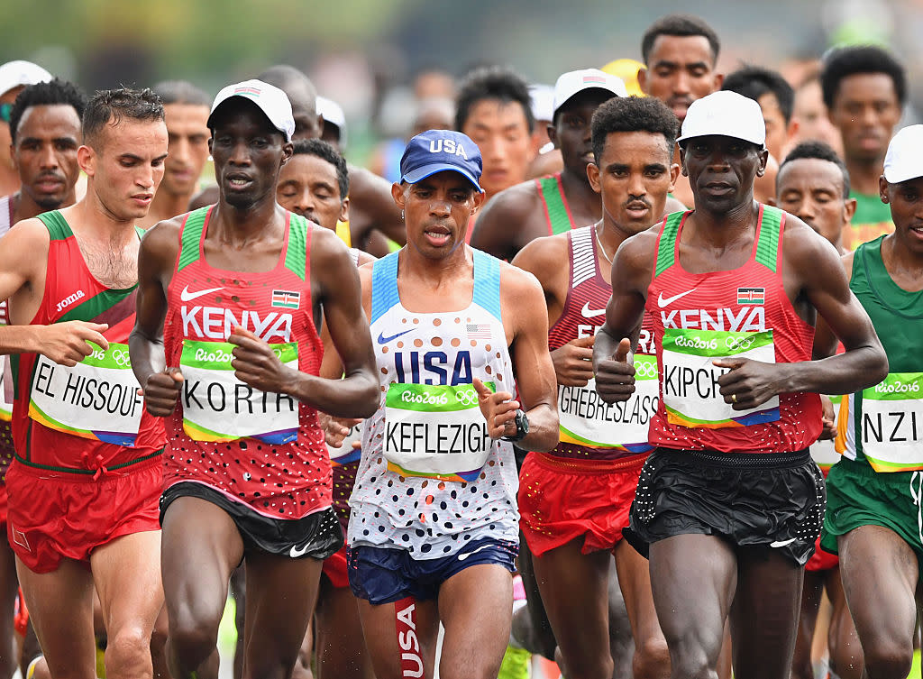 Kenyan marathoners Wesley Korir (left) and Eilud Kipchoge sandwich U.S. distance star Meb Keflezighi in Rio. (Getty Images)