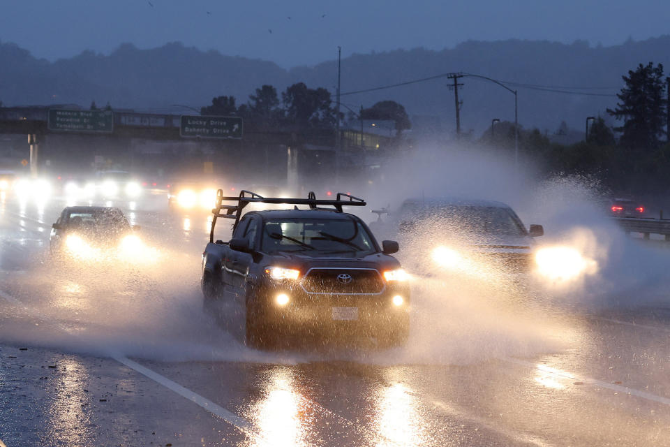 GREENBRAE, CALIFORNIA - JANUARY 04: Cars drive along Highway 101 as rain falls on January 04, 2023 in Greenbrae, California. Gov. Gavin Newsom issued a statewide emergency declaration today as a powerful storm began hitting the coast on the heels of record rainfall that fell over the weekend.  (Justin Sullivan / Getty Images)