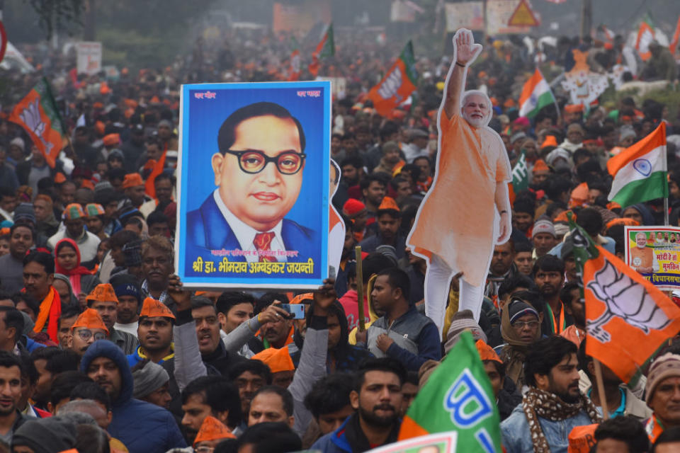 A BJP supporter holds up an image of B.R Ambedkar during a rally for Indian Prime Minister Narendra Modi on December 22, 2019 in New Delhi, India. | Sanchit Khanna/Hindustan Times via Getty Images—2019 Hindustan Times