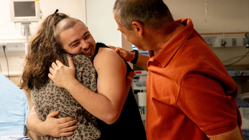 Almog Meir Jan, a rescued hostage, embraces his loved ones after the military said that Israeli forces have rescued four hostages alive. - Israeli Army/Handout via Reuters