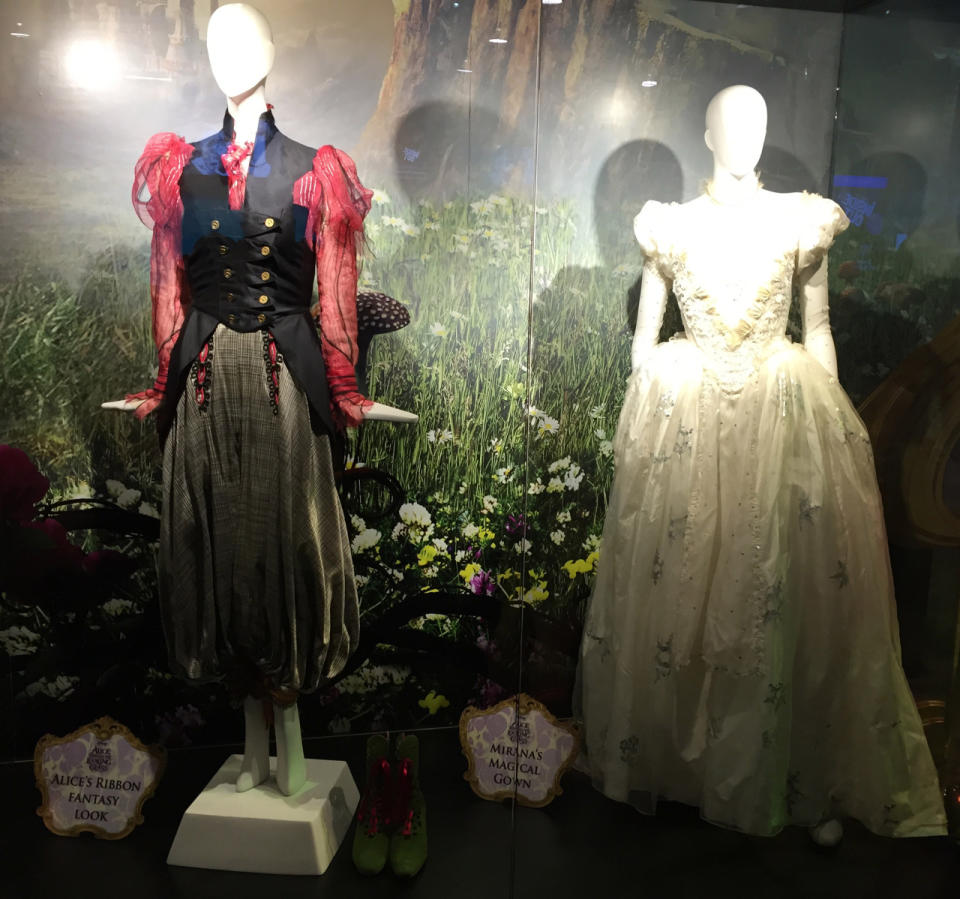 On the left is Alice’s "fantasy look,” complete with green boots; on the right right is the magical gown worn by Mirana of Mamoreal (aka Anne Hathaway’s White Queen).