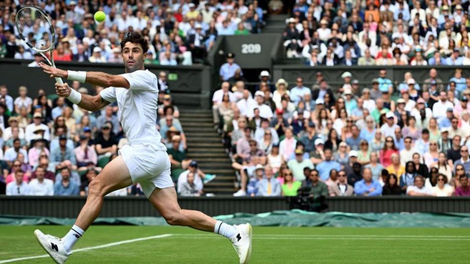 Jordan Thompson playing a shot on Centre Court