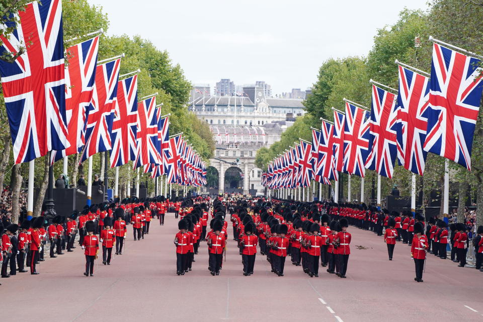 The State Gun Carriage carries the coffin of Queen Elizabeth II, draped in the Royal Standard with the Imperial State Crown and the Sovereign's orb and sceptre, in the Ceremonial Procession following her State Funeral at Westminster Abbey, London. Picture date: Monday September 19, 2022. (Photo by Ian West/PA Images via Getty Images)