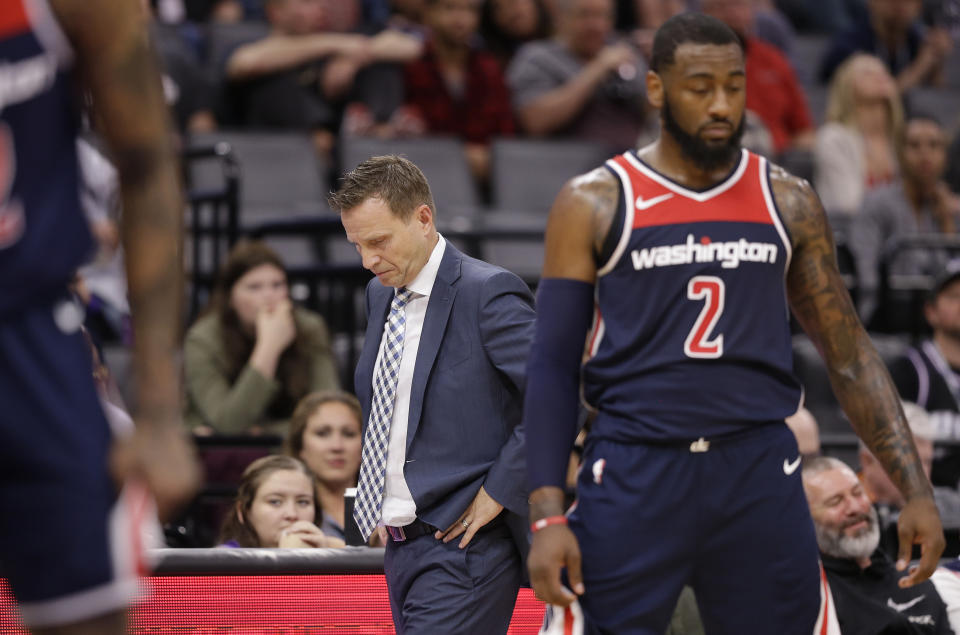 Scott Brooks (left), John Wall and the Wizards have limped to a 1-5 record to start the NBA season. (AP)