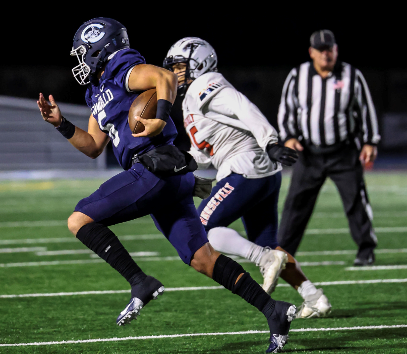 Camarillo quarterback Brody Meyer runs away from a Roosevelt defender during the Scorpions' 35-20 at home in a CIF-SS Division 4 first-round playoff game on Friday, Nov. 4, 2022.