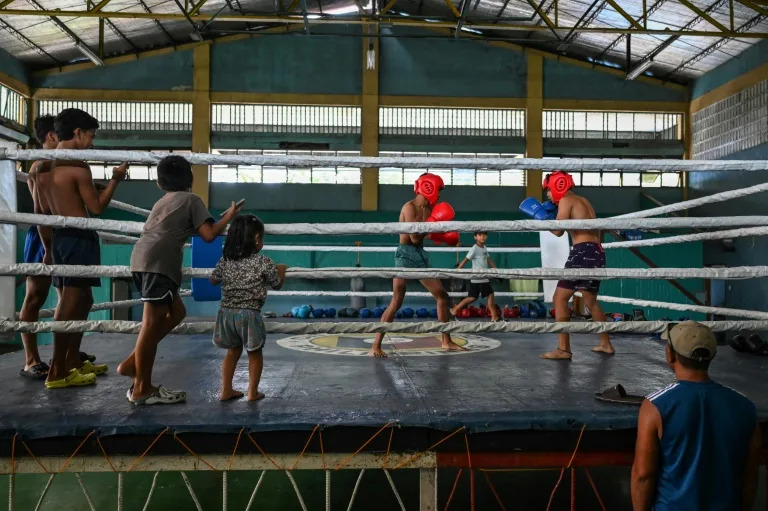 Young boxers train at the gym in Bago City under the buzz of old electric fans straining to give some relief from the oppressive tropical heat (JAM STA ROSA)