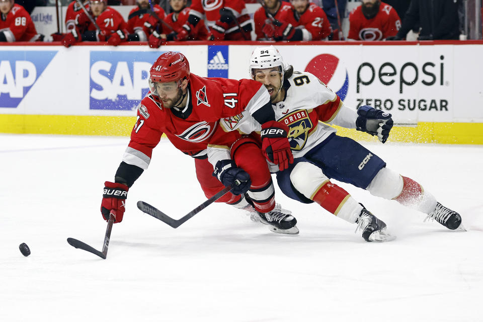 Carolina Hurricanes' Shayne Gostisbehere (41) tangles with Florida Panthers' Ryan Lomberg (94) during the third period of Game 1 of the NHL hockey Stanley Cup Eastern Conference finals in Raleigh, N.C., Thursday, May 18, 2023. (AP Photo/Karl B DeBlaker)