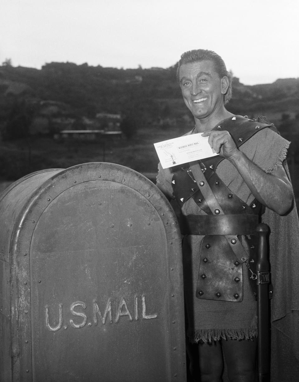 Kirk Douglas, still in costume while filming Spartacus, mails off his ballot for the Academy Awards in 1960.