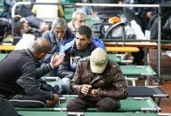 Men talk at a migrant registration centre in Passau, Germany October 8, 2015. REUTERS/Michaela Rehle