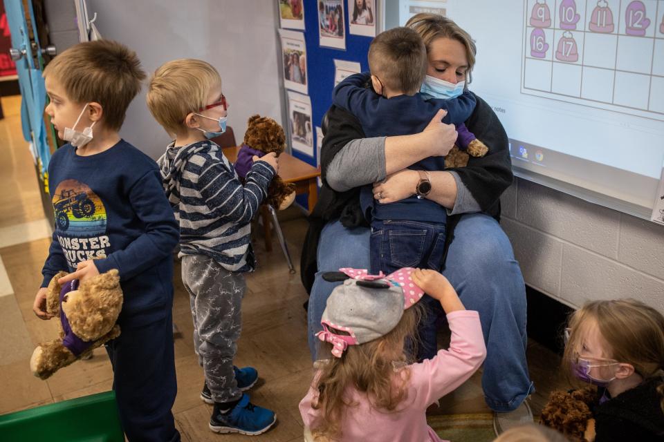 Pre-school teacher Kammie King, right, hugs students as classes resume at Dawson Springs Independent Schools for the first time since December's tornado. Jan. 18, 2022