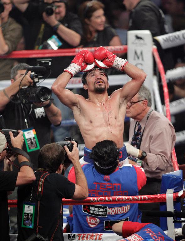 Manny Pacquiao of the Philippines celebrates victory over Timothy Bradley of the US in their WBO welterweight title fight on April 12, 2014 at the MGM Grand Garden Arena in Las Vegas, Nevada