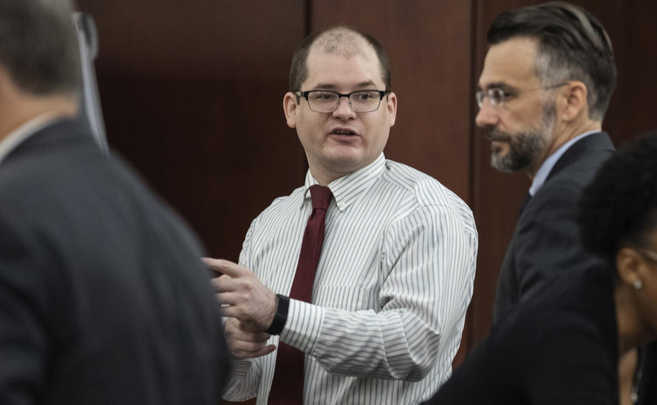 Timothy Jones Jr., center, charged with killing his five children, speaks with his attorneys, Boyd Young, left, and Casey Secor during his trial in Lexington, S.C., Wednesday, May 22, 2019. Lawyers defending Jones turned Wednesday to brain science in an effort to spare their client from the death penalty. (Tracy Glantz/The State via AP, Pool)