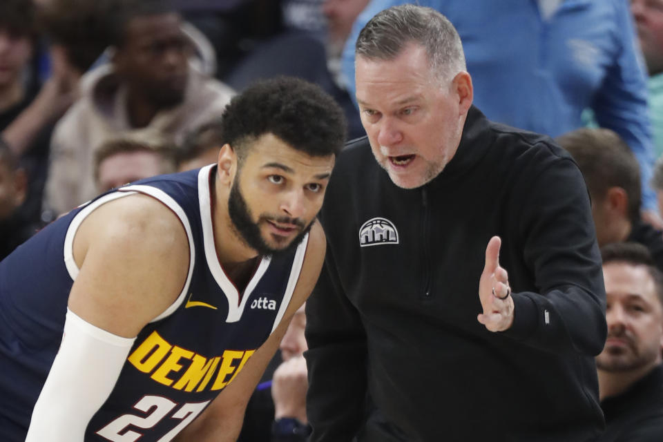 Denver Nuggets head coach Michael Malone directs guard Jamal Murray (27) as they play the Minnesota Timberwolves in the third quarter of an NBA basketball game Wednesday, Nov. 1, 2023, in Minneapolis. The Timberwolves won 110-89. (AP Photo/Bruce Kluckhohn)