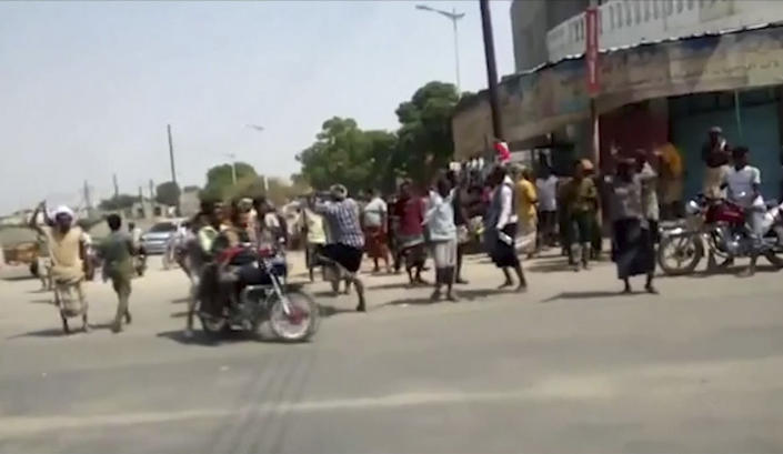 In this frame grab from video provided by Yemen Today, residents cheered and chanted as Yemeni army vehicles entered Zinjibar, Yemen, Wednesday, Aug. 28, 2019. Yemeni officials and local residents say forces loyal to the country's internationally recognized government have wrested control of the capital of southern Abyan province from separatists backed by the United Arab Emirates. They say government forces on Wednesday pushed the UAE-backed militia, known as the Security Belt, out of Zinjibar after clasher that left at least one dead and 30 wounded fighters. (Yemen Today via AP)