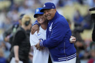 Pink, left, greets Los Angeles Dodgers manager Dave Roberts after throwing out the first pitch before a baseball game between the Atlanta Braves and the Los Angeles Dodgers in Los Angeles, Saturday, May 4, 2024. (AP Photo/Ashley Landis)