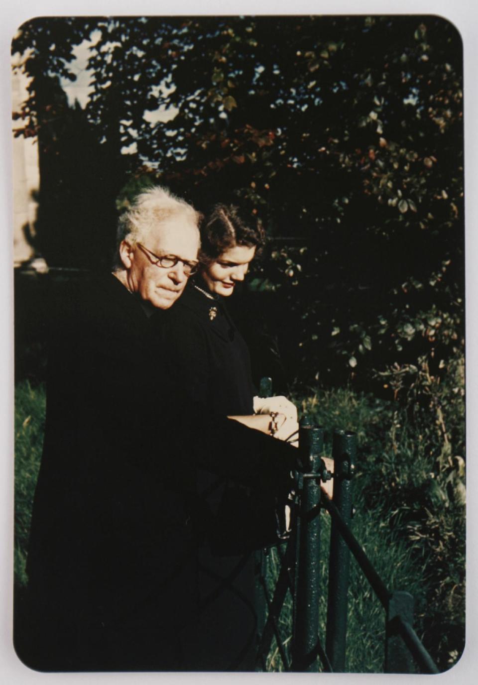 In this image made available by Sheppard's Irish Auction House made available on Wednesday May 14, 2014 shows Rev. Joseph Leonard with Jacqueline Kennedy at All Hallows College in Dublin Ireland in 1950. Letters written by Jacqueline Kennedy to an Irish priest have revealed new details about her closely guarded private thoughts. The letters are set to be auctioned next month and could fetch up to $1.6 million. The more than 30 letters were written to the Rev. Joseph Leonard. They were recently discovered in a drawer at All Hallows College. In one, she questioned her faith after the assassination of President John F. Kennedy. "I am so bitter against God," she wrote a few months after the assassination of her husband. (AP Photo/Sheppard's Irish Auction House) NO ARCHIVE ONE TIME USE ONLY ONLY TO BE USE IN CONNECTION WITH STORY RELATED TO THE AUCTION