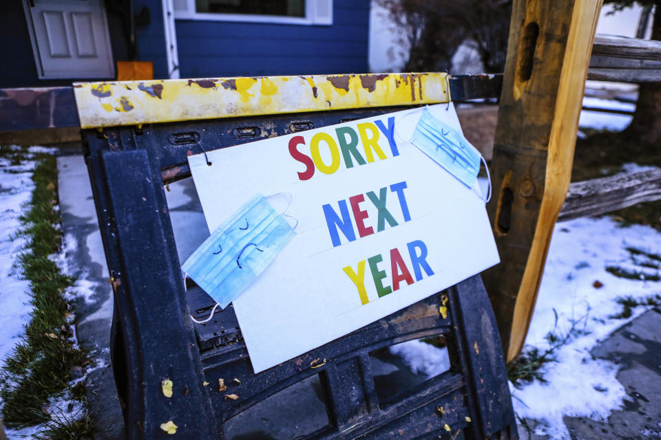 A sign indicates that residents of a house will not be handing out treats for Halloween during the coronavirus pandemic, Friday, Oct. 30, 2020, in Minturn, Colo. (AP Photo/Vail Daily via AP)