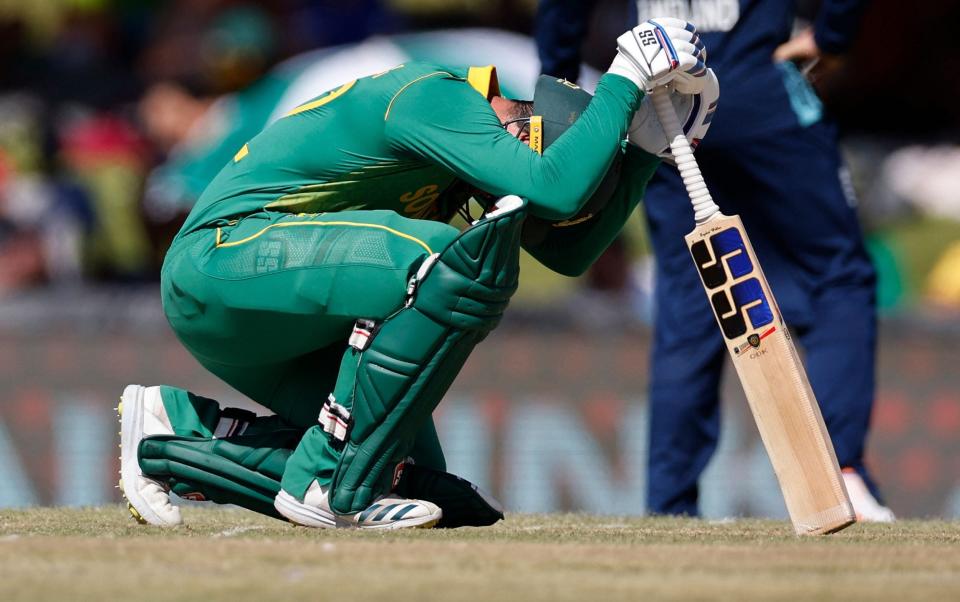 South Africa's Quinton de Kock kneels after being hit by a ball during the second one day international - MARCO LONGARI/AFP via Getty Images