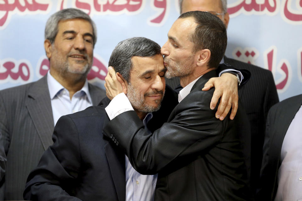 Hamid Baghaei, right, close ally of former Iranian President Mahmoud Ahmadinejad kisses his head after registering their candidacy for the upcoming presidential elections at the Interior Ministry in Tehran, Iran, Wednesday, April 12, 2017. Ahmadinejad on Wednesday unexpectedly filed to run in the country's May presidential election, contradicting a recommendation from the supreme leader to stay out of the race. Other close ally of Ahmadinejad, Esfandiar Rahim Mashie accompanies them. (AP Photo/Ebrahim Noroozi)