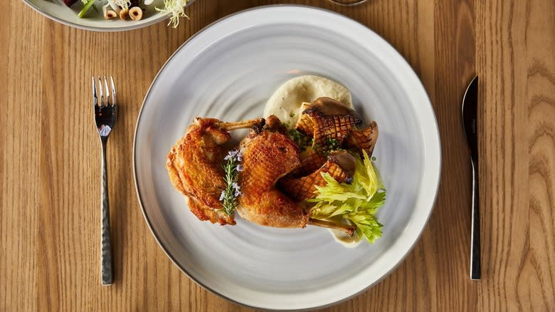 Plated chicken with knife and fork 