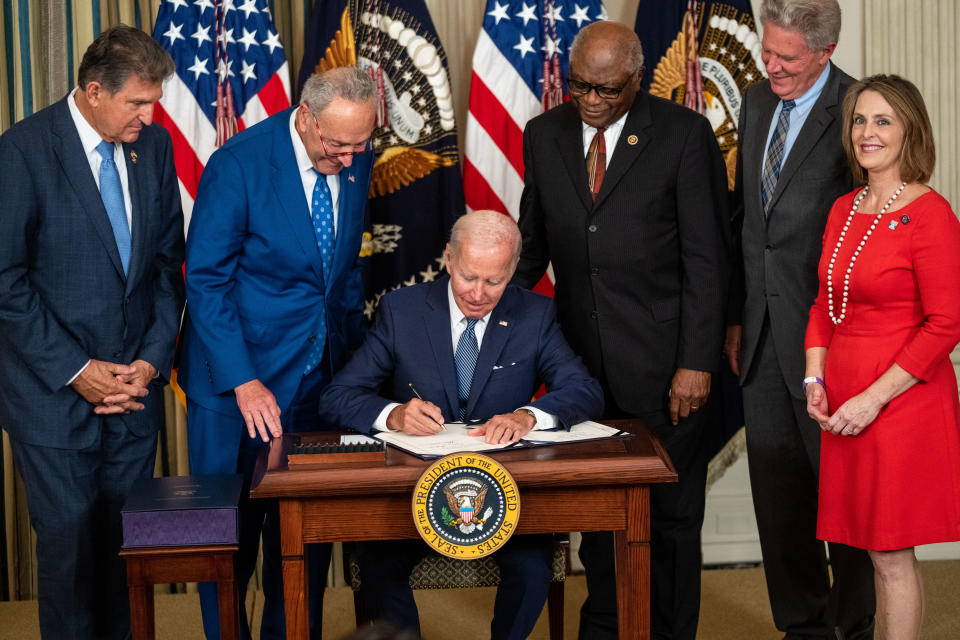 WASHINGTON, DC - AUGUST 16: President Joe Biden, center, flanked by (L to R) Sen. Joe Manchin (D-WV), Senate Majority Leader Chuck Schumer (D-NY), House Majority Whip Jim Clyburn (D-SC), Rep. Frank Pallone (D-NJ), and Rep. Kathy Castor (D-FL) delivers remarks and signs H.R. 5376, the Inflation Reduction Act of 2022 into law in the State Dining Room of the White House on Tuesday, Aug. 16, 2022 in Washington, DC. The 737 billion dollar bill focuses on climate change, lowering health care costs and creating clean energy jobs. (Kent Nishimura / Los Angeles Times via Getty Images)