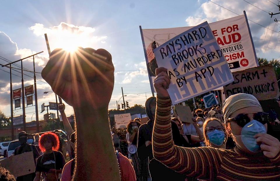 Protesters gather at University Avenue at the Wendy's restaurant Saturday where Rayshard Brooks, 27, shot to death by Atlanta police late Friday after a struggle in the parking lot.