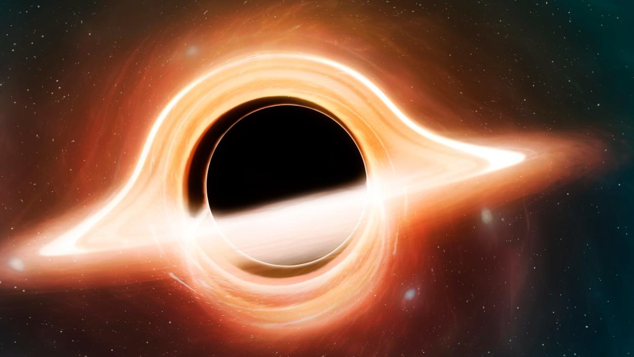  A dark black hole surrounded by glowing orange gases. 