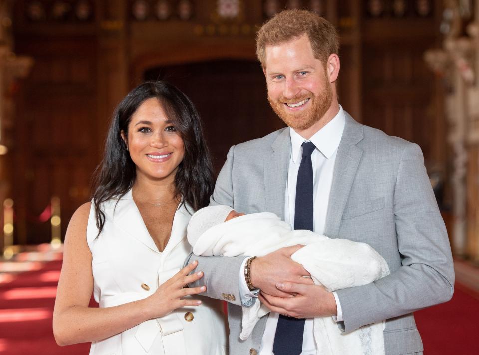 Britain's Prince Harry, Duke of Sussex (R), and his wife Meghan, Duchess of Sussex, pose for a photo with their newborn baby son, Archie Harrison Mountbatten-Windsor, in St George's Hall at Windsor Castle in Windsor, west of London on May 8, 2019. 