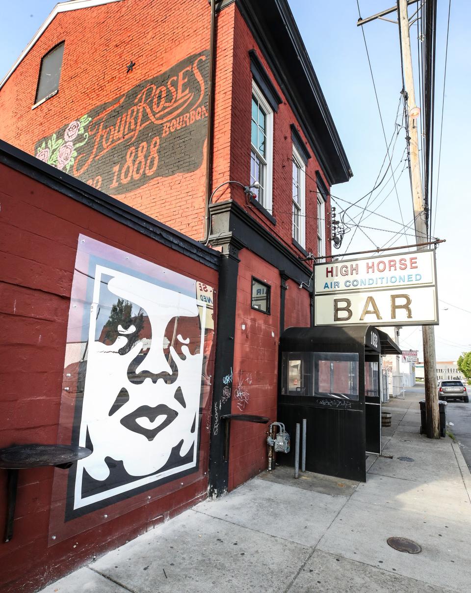 Shepard Fairey's "OBEY" artwork is protected by a sheet of plexiglass at the High Horse Bar on Story Avenue. Fairey, in town to paint a mural of Muhammad Ali, stopped by to add OBEY to the front of the bar late Tuesday night.