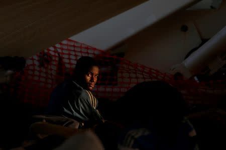 A migrant rests on the deck of the Migrant Offshore Aid Station (MOAS) ship Topaz Responder after being rescued around 20 nautical miles off the coast of Libya, June 23, 2016. Picture taken June 23, 2016. REUTERS/Darrin Zammit Lupi