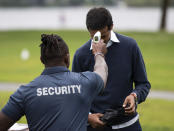 A security guard takes an attendee's temperature as a precaution against COVID-19 as they arrive at an event at Mooney's Bay Park in Ottawa, Ontario, on the Labour Day holiday weekend, Monday, Sept. 7, 2020. (Justin Tang/The Canadian Press via AP)