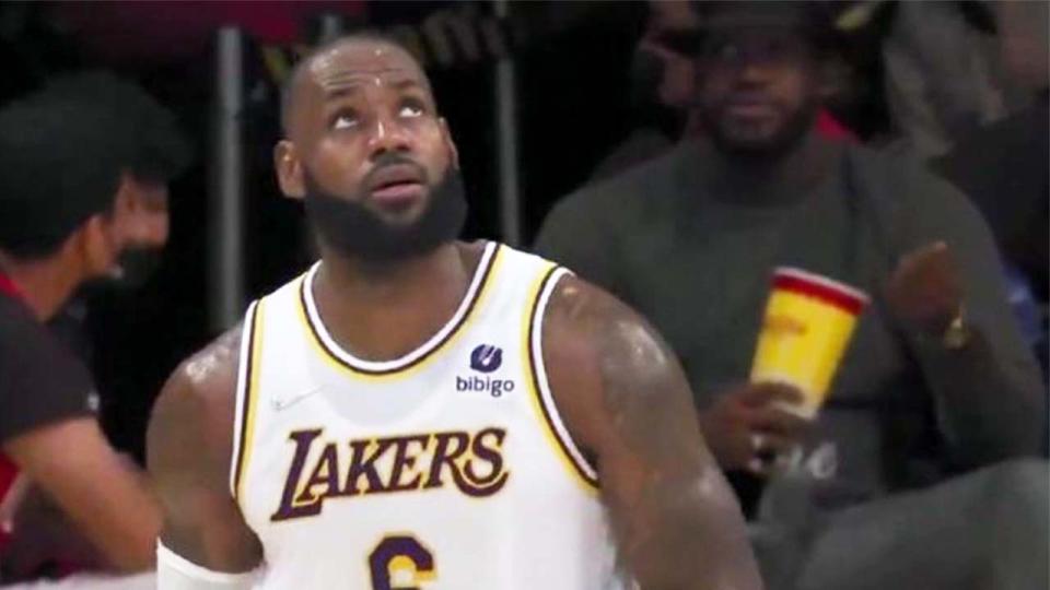 LeBron James (pictured left) look up at the clock during a game.