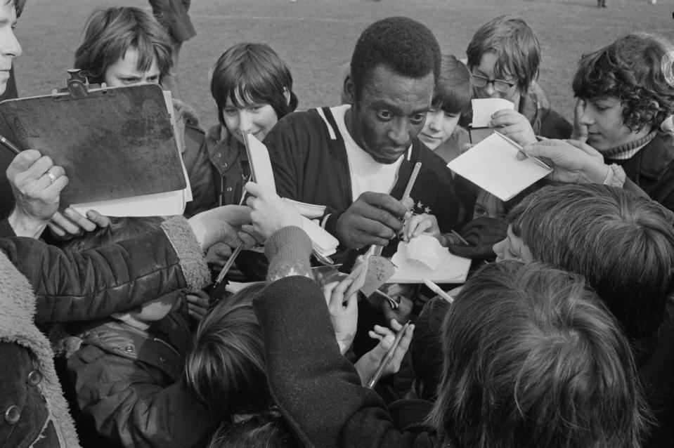 Pele meets young fans at Craven Cottage stadium, home ground of Fulham FC, London, UK, 12th March 1973. (Getty Images)