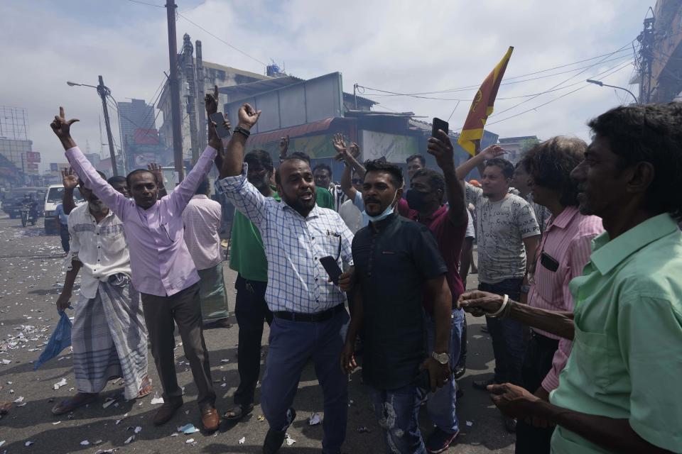 Supporters of Acting President and Prime Minister Ranil Wickremesinghe celebrate after he was elected president in Colombo, Sri Lanka, in Colombo, Sri Lanka, Wednesday, July 20, 2022. Sri Lankan lawmakers chose six-time Prime Minister Wickremesinghe as president Wednesday, defying the risk the vote would re-ignite turmoil among a public outraged by the South Asian country's dire economic, humanitarian and political crisis. (AP Photo/Eranga Jayawardena)