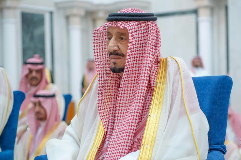 Saudi Arabia's ageing King Salman, seen here performing Eid Al-Fitr prayers on April 10, has been admitted to hospital for "routine examinations" (-)