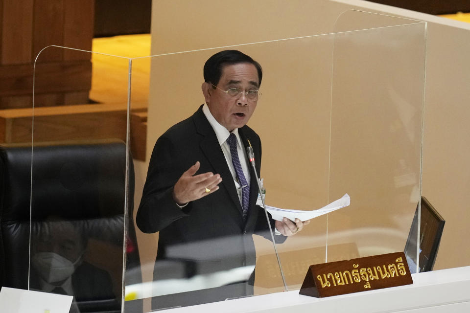 Thailand Prime Minister Prayuth Chan-ocha answers questions during a no-confidence debate at the Parliament in Bangkok, Thailand, Tuesday, July 19, 2022. Thailand's opposition parties on Tuesday began a no-confidence debate targeting Prayuth and ten of his Cabinet members, who face accusations of corruption and economic mismanagement. (AP Photo/Sakchai Lalit)