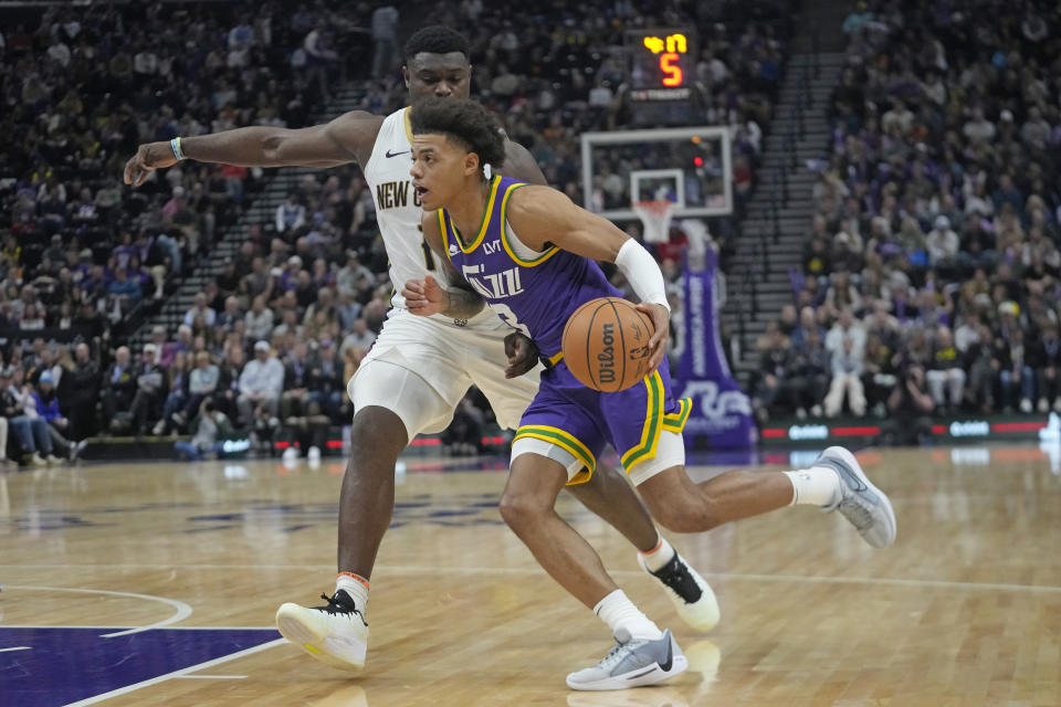 Utah Jazz guard Keyonte George (3) drives around New Orleans Pelicans forward Zion Williamson, rear, during the first half of an NBA basketball game Monday, Nov. 27, 2023, in Salt Lake City. (AP Photo/Rick Bowmer)