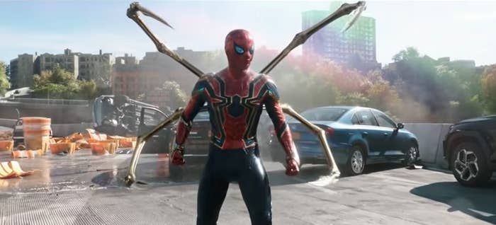 Spider-Man on a ruined highway with his Iron Spider suit on and his four robot legs out in "Spider-Man: No Way Home"