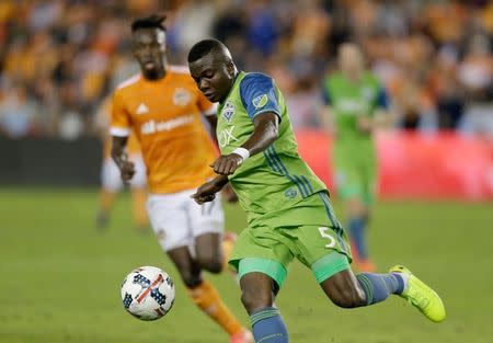 Nov 21, 2017; Houston, TX, USA; Seattle Sounders defender Nouhou Tolo (5) kicks the ball away from Houston Dynamo forward Alberth Elis (17) during the second half in the first leg of the MLS Western Conference Championship at BBVA Compass Stadium. Thomas B. Shea-USA TODAY Sports