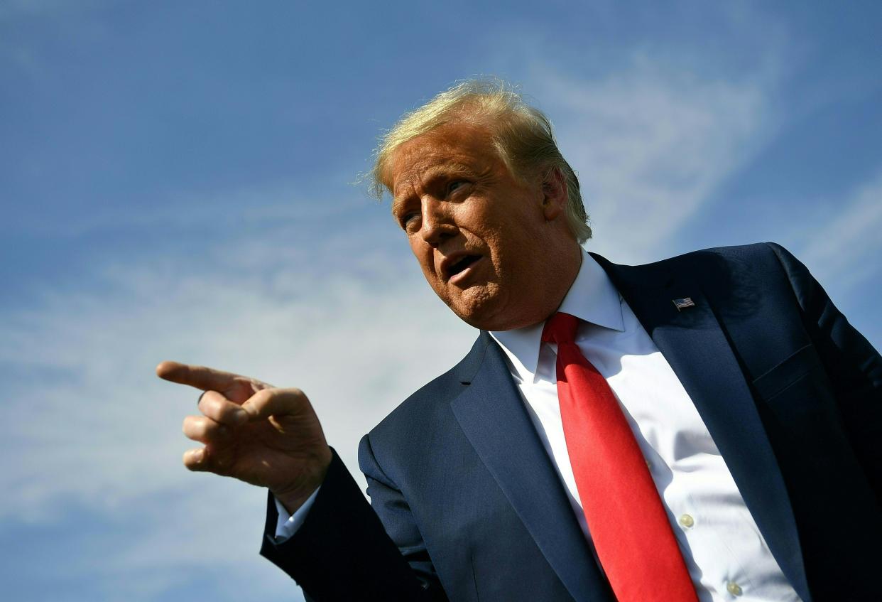 US President Donald Trump speaks to members of the media upon arrival at Phoenix Sky Harbor International Airport in Phoenix, Arizona on October 19, 2020. Trump is heading to Prescott, Arizona for a campaign rally. - US President Donald Trump went after top government scientist Anthony Fauci in a call with campaign staffers on October 19, 2020, suggesting the hugely respected and popular doctor was an 